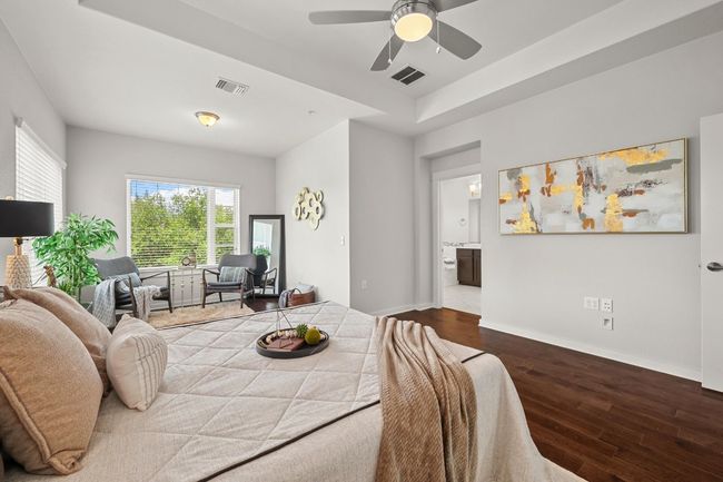 Designed for relaxation, the primary bedroom features dual walk-in closets, providing plenty of space for all your wardrobe essentials | Image 23