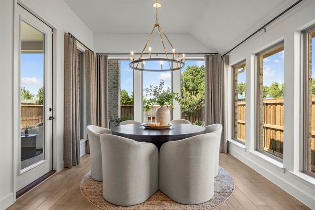 Dining area featuring a chandelier, wood finished floors, and vaulted ceiling | Image 18