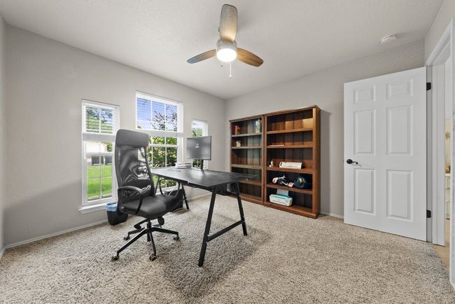 Bedroom/home office with ceiling fan and baseboards, and comfortable carpet | Image 20
