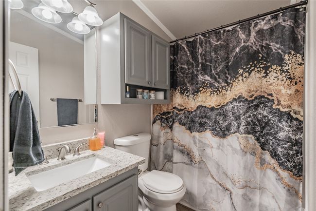 Bathroom with crown molding, vanity, and curtained shower | Image 26