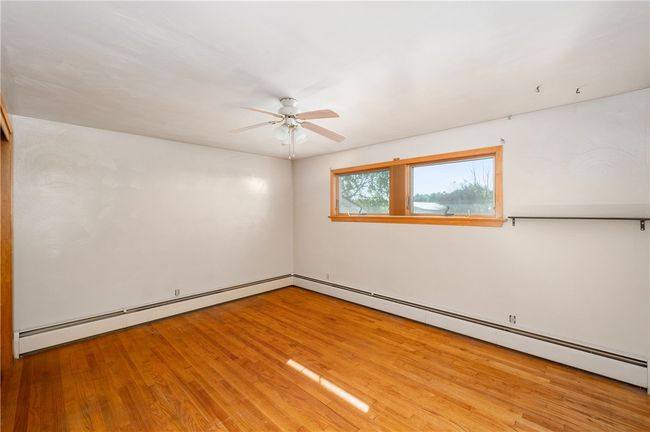 Primary Bedroom with hardwood floor | Image 32