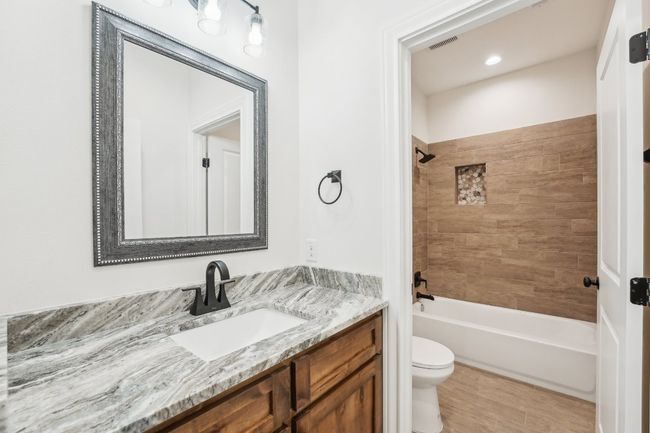 Full bathroom featuring visible vents, toilet, shower / bathing tub combination, and vanity | Image 29