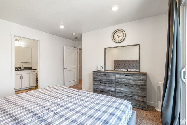 Bedroom featuring carpet flooring, ensuite bath, baseboards, and recessed lighting | Image 21
