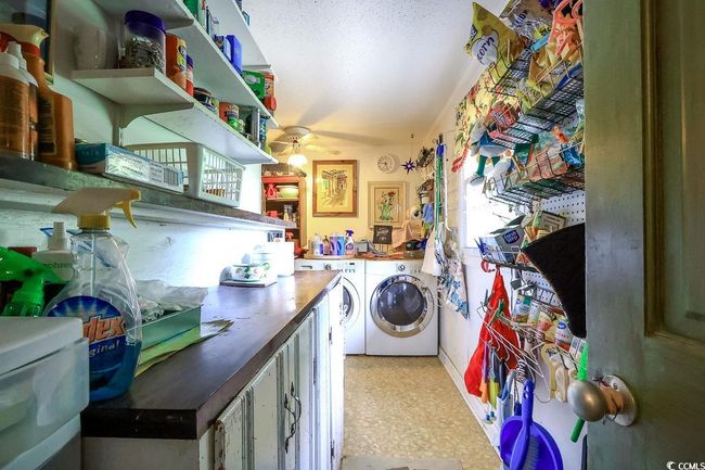 Laundry room with washer and clothes dryer, a ceiling fan, and healthy amount of natural light | Image 20