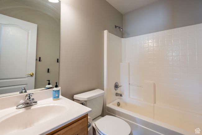 Bathroom featuring toilet, vanity, and shower combination | Image 24