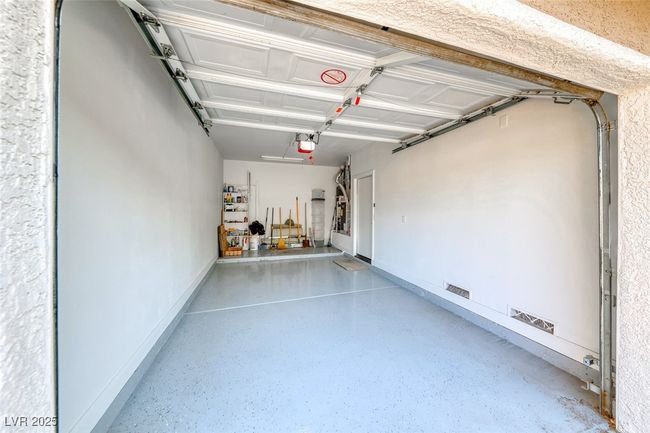 Garage with a garage door opener and baseboards | Image 30
