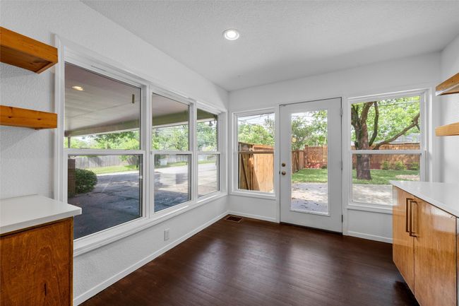 Unfurnished sunroom with healthy amount of natural light, baseboards, wood finished floors, and recessed lighting | Image 13