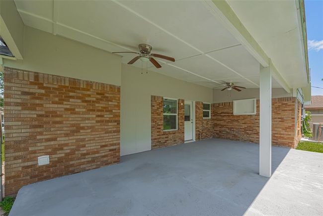 The rear patio spans a generous portion of the backyard, offering endless potential for lounging, dining, or entertaining outdoors. | Image 27