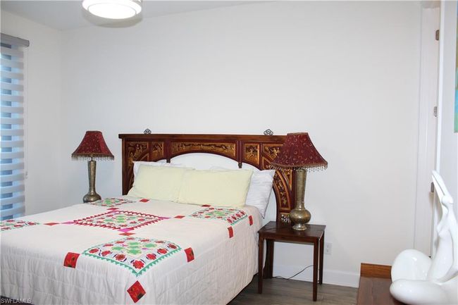 Guest Bedroom featuring baseboards and wood finished floors | Image 17