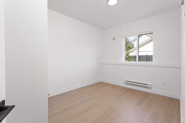 Empty room with a baseboard radiator, baseboards, and light wood finished floors | Image 23
