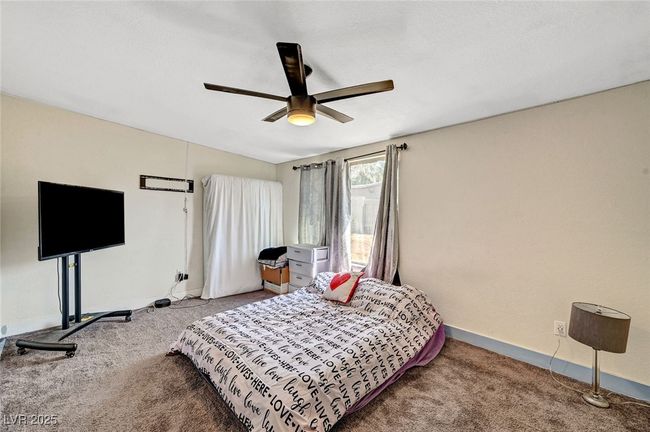 Carpeted bedroom featuring baseboards and a ceiling fan | Image 27
