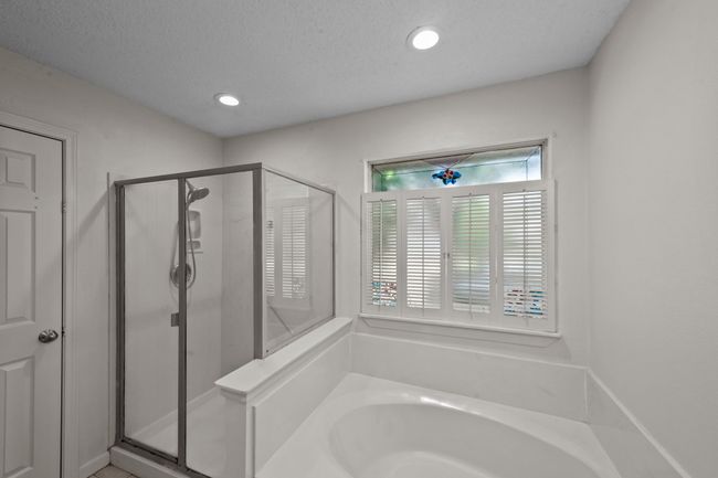 Full bathroom featuring a separate shower, a garden tub, access to walk-in closet and recessed lighting | Image 25