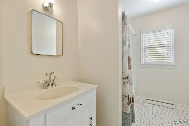 Full bath featuring baseboard heating, baseboards, a shower with curtain, and vanity | Image 19
