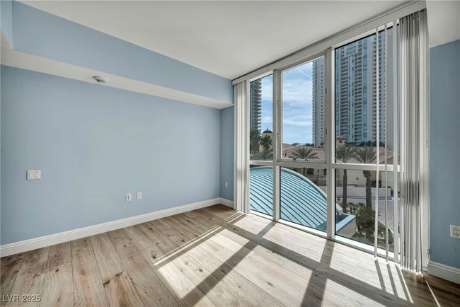 Unfurnished room with expansive windows, wood finished floors, and baseboards | Image 30