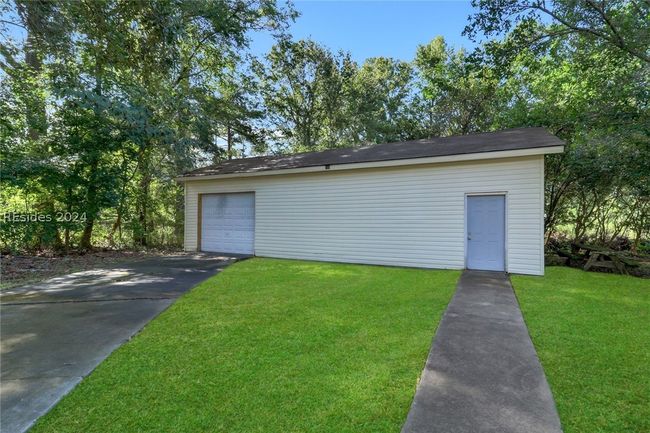 Garage featuring a yard | Image 33