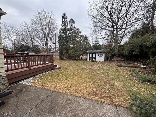 View of yard with a deck, a storage unit, and an outdoor structure | Image 30