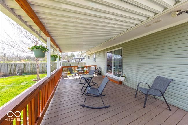 newer deck with a newer patio awning perfect for outdoor dining, relaxing, or entertaining | Image 9