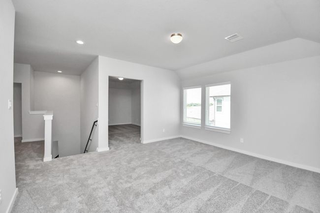 Come upstairs and enjoy a day of leisure in this fabulous game room! This is the perfect hangout spot or adult game room! Features plush carpet, high ceilings, custom paint and windows for plenty of natural light. | Image 38