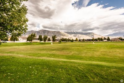 View of community featuring a mountain view and a lawn | Image 2