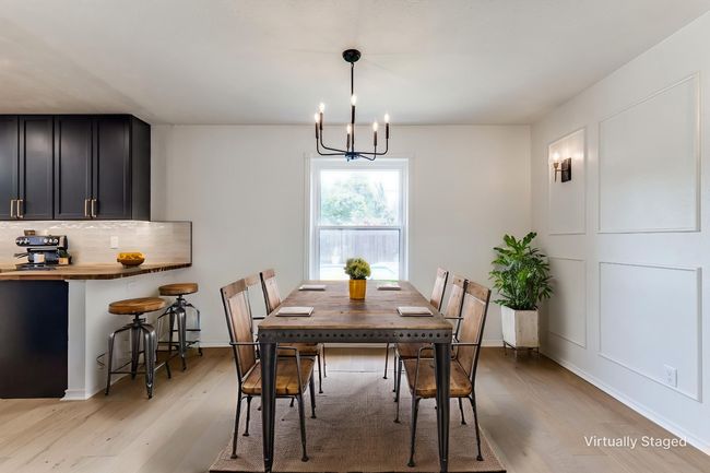 Dining space featuring light wood-style floors and a chandelier | Image 8