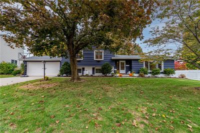 Tri-level home featuring a garage and a front lawn | Image 3