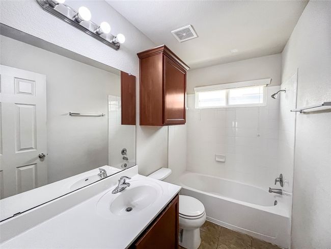 Bathroom featuring vanity, shower / bath combination, and tile patterned floors | Image 16