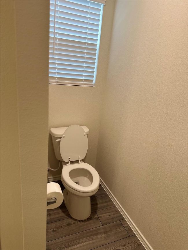 Bathroom featuring wood finished floors and toilet | Image 11