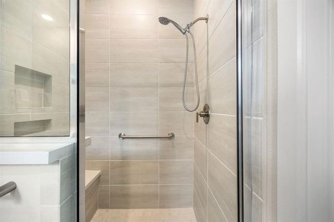Primary shower with grab bars and bench | Image 19