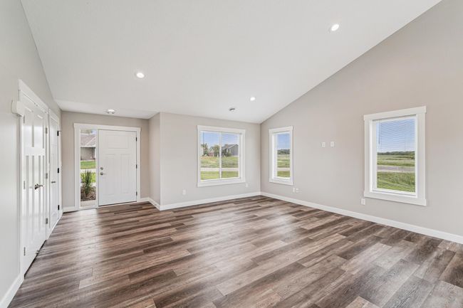 Vaulted ceilings and recessed lighting are featured throughout the main living area. | Image 6