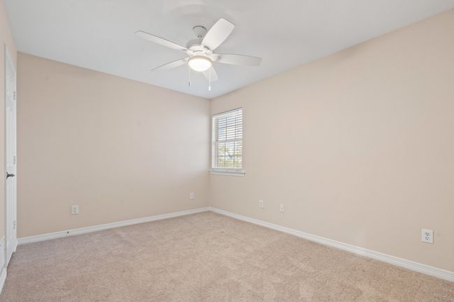 Upstairs bedroom 1 right off of the staircase. Ceiling fan, natural light, walk in closet and private bath. New carpet. | Image 29