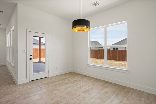 Spare room featuring light wood-type flooring | Image 9