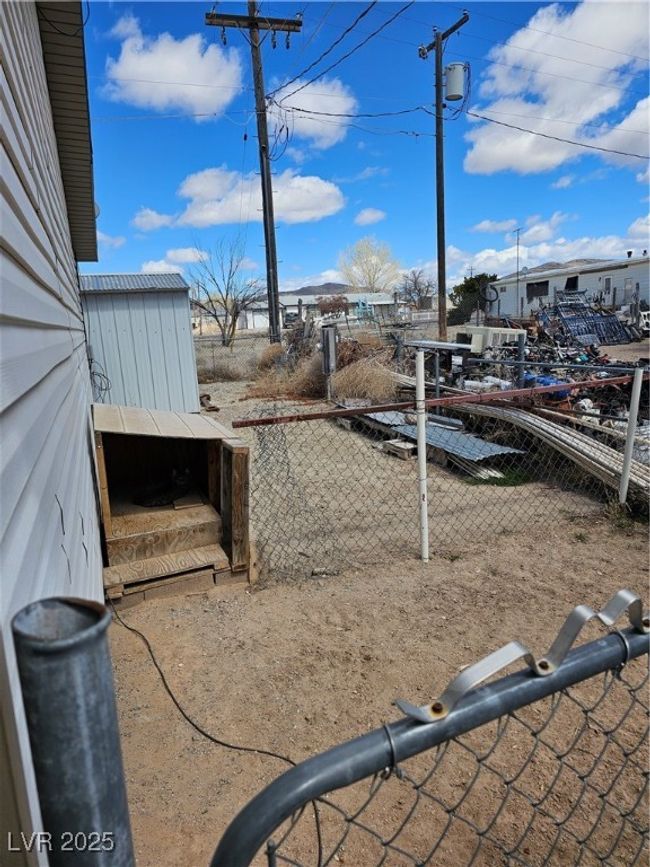 View of yard featuring an outbuilding and fence | Image 32