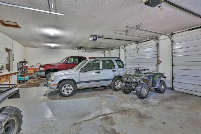 Over sized attached 3 car garage with individual roll up doors. | Image 26