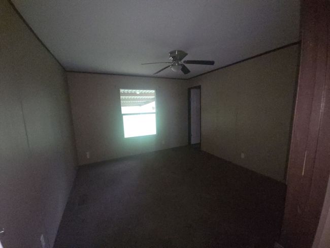 Spare room with ceiling fan | Image 12