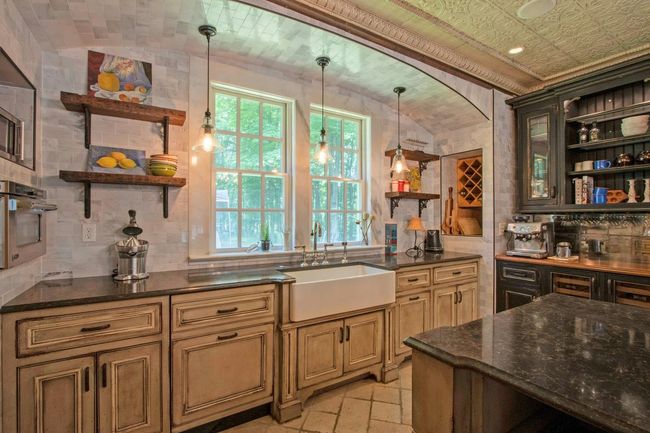 Kitchen featuring open shelves, a sink, stainless steel oven, tasteful backsplash, and vaulted ceiling | Image 11