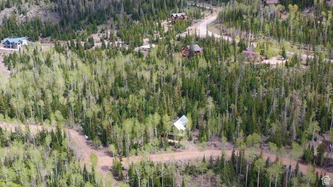 Aerial view of property and surrounding area featuring a heavily wooded area | Image 62