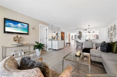 Living room with wood-type flooring and a chandelier | Image 2