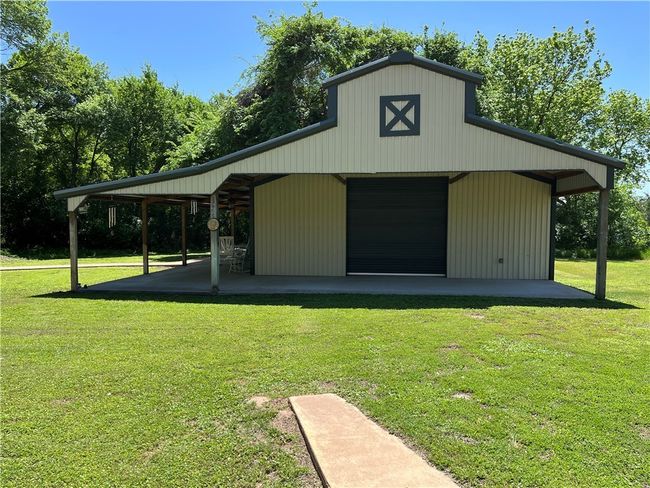 Detached garage has overhead doors on both ends for easy access | Image 7
