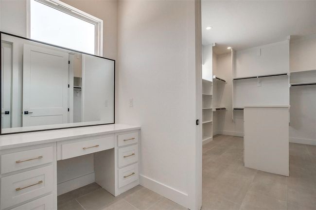 Bathroom featuring tile patterned flooring, vanity, a spacious closet, baseboards, and recessed lighting | Image 27