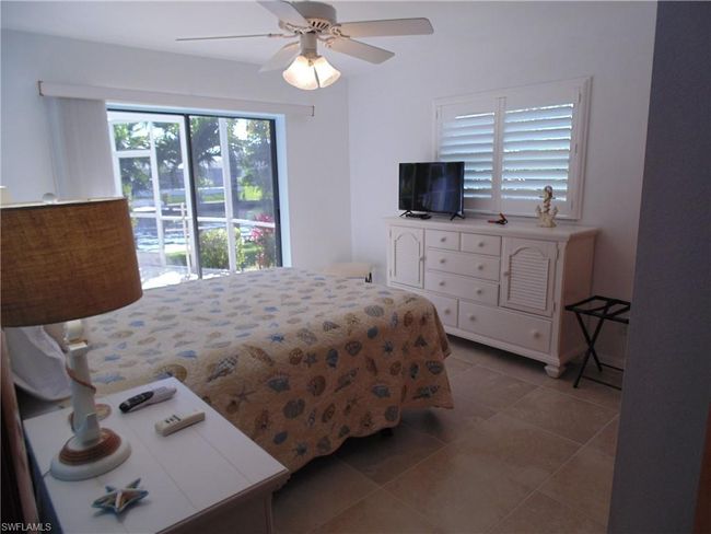 Bedroom with tile patterned flooring, a ceiling fan, and access to exterior | Image 18