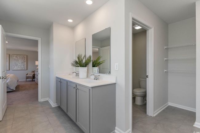 Ensuite bathroom with a sink, connected bathroom, tile patterned floors, and toilet | Image 17