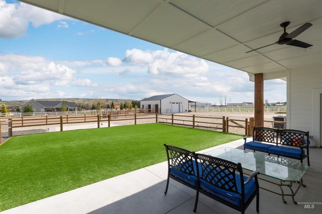 View of patio with ceiling fan, a view of countryside, and outdoor dining area | Image 35