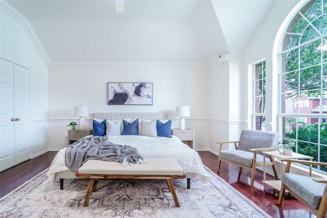 Bedroom featuring dark wood-style floors, vaulted ceiling, and ornamental molding | Image 25