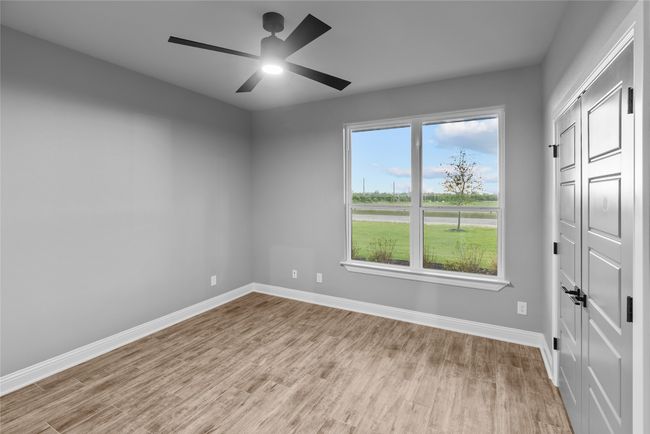 Empty room featuring wood finished floors and a ceiling fan | Image 22