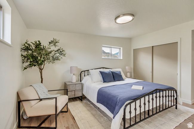 Bedroom featuring baseboards, light wood-style floors, and a closet | Image 14