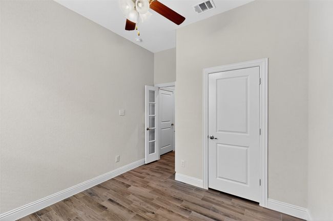 Unfurnished bedroom with wood finished floors and a ceiling fan | Image 32