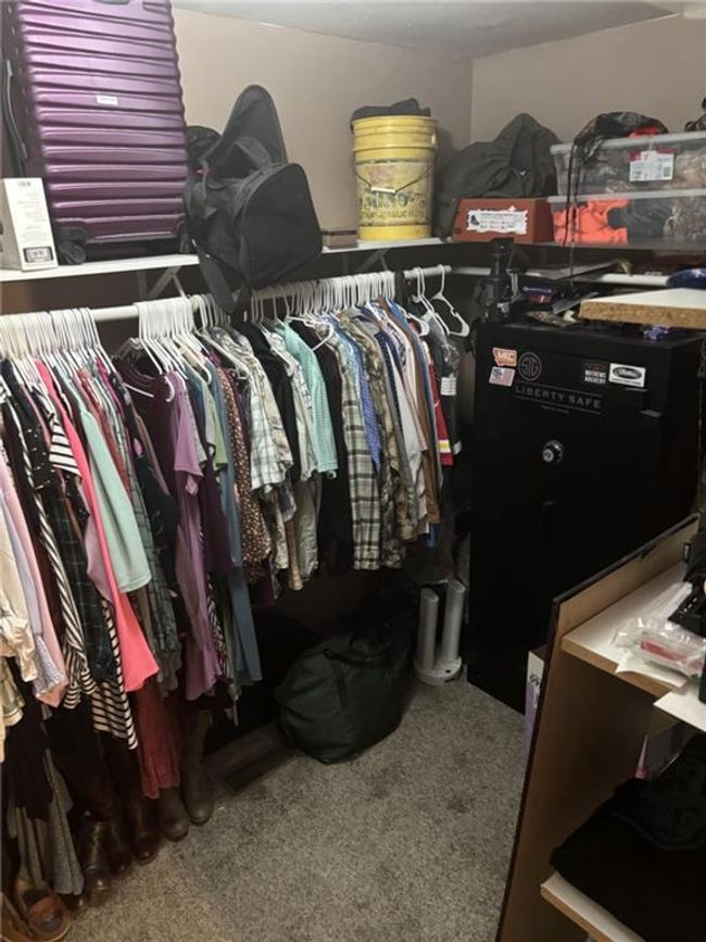 Walk in closet featuring carpet | Image 32