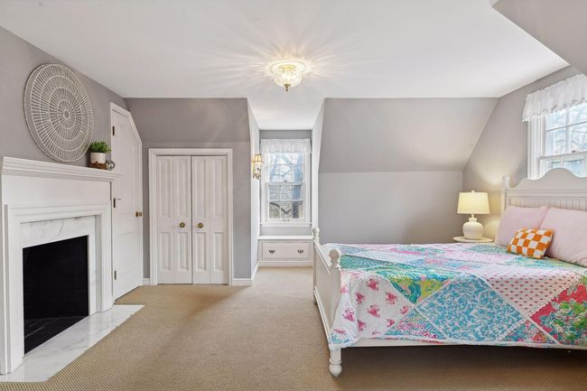 One of two upper-level bedrooms - charming window seat with built in storage. | Image 18