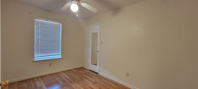 Unfurnished room with light wood-style flooring, baseboards, and a ceiling fan | Image 11
