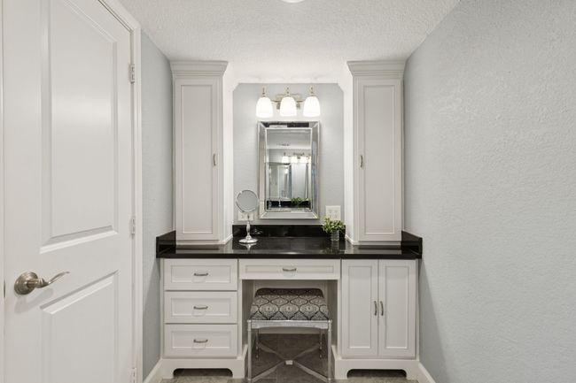 Bathroom featuring a textured ceiling, vanity, baseboards, and a textured wall | Image 21